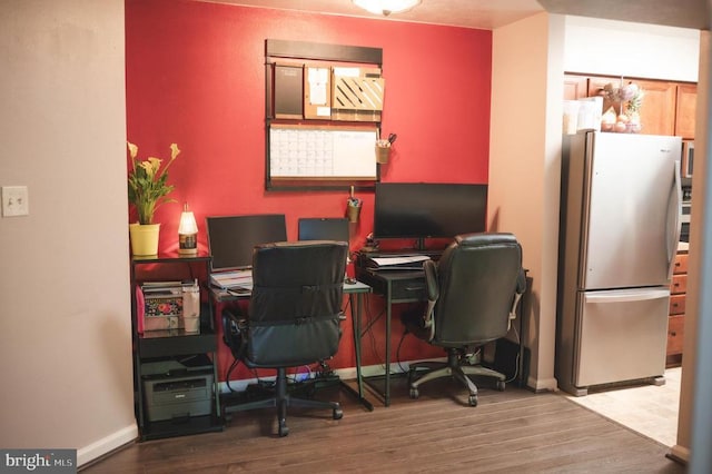 home office with wood finished floors and baseboards