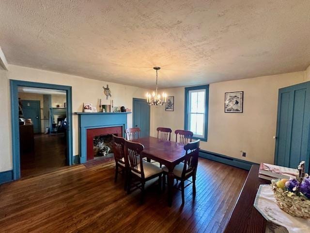 8892 Highland Tpke, Tpke, VA 24458 - dining room with an inviting chandelier, a fireplace with flush hearth, a textured ceiling, baseboards, and hardwood / wood-style flooring