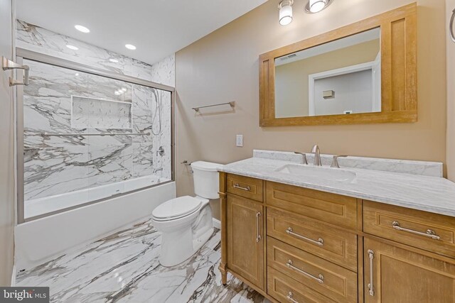 bathroom featuring marble finish floor, shower / bath combination with glass door, recessed lighting, toilet, and vanity