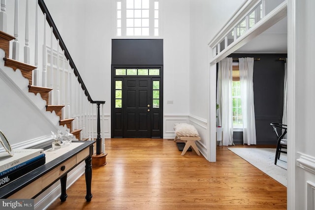 13904 Hunting Run Dr, Fredericksburg, VA 22407 - entryway featuring plenty of natural light, a high ceiling, light wood-type flooring, stairs, and a decorative wall