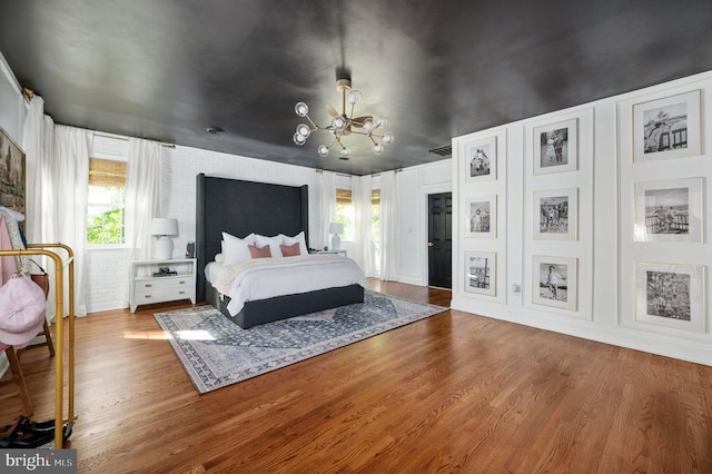 13904 Hunting Run Dr, Fredericksburg, VA 22407 - bedroom featuring a chandelier, multiple windows, and wood finished floors
