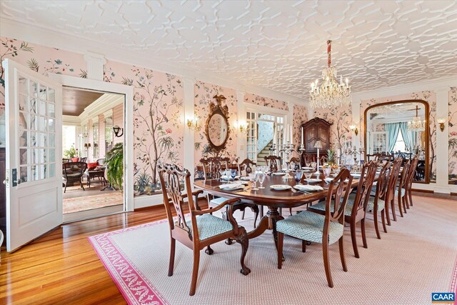 356 Routier Hill Rd, Hot Springs, VA 24445 - dining room with crown molding, a chandelier, plenty of natural light, light wood-style flooring, and wallpapered walls