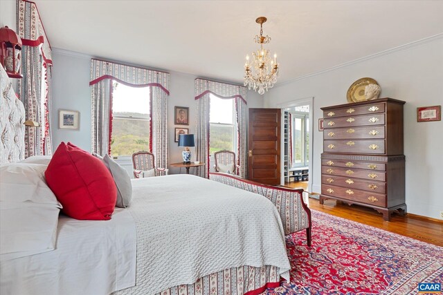 356 Routier Hill Rd, Hot Springs, VA 24445 - bedroom with a chandelier, crown molding, wood finished floors, and baseboards