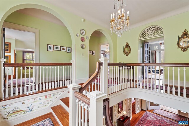 356 Routier Hill Rd, Hot Springs, VA 24445 - hallway featuring a chandelier, an upstairs landing, and wood finished floors