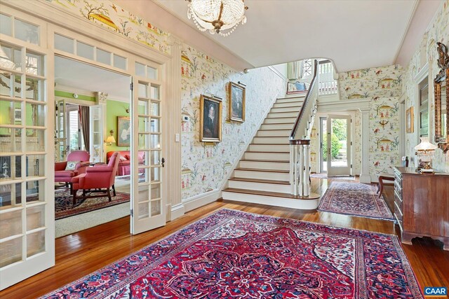 356 Routier Hill Rd, Hot Springs, VA 24445 - entrance foyer featuring wallpapered walls, french doors, hardwood / wood-style flooring, stairs, and a chandelier
