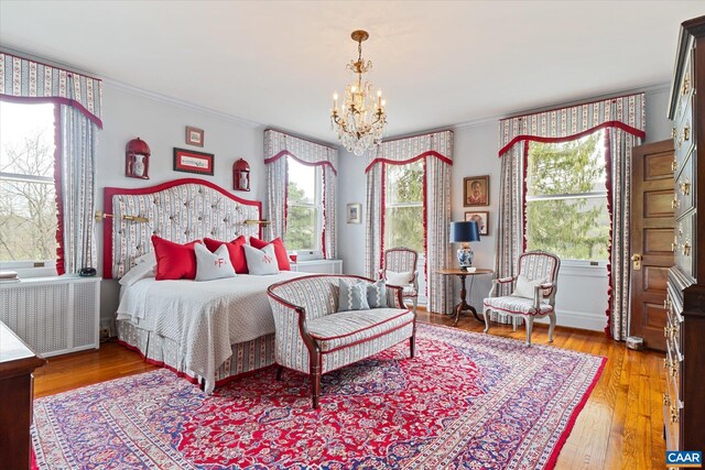 356 Routier Hill Rd, Hot Springs, VA 24445 - bedroom featuring crown molding, a chandelier, wood finished floors, baseboards, and radiator