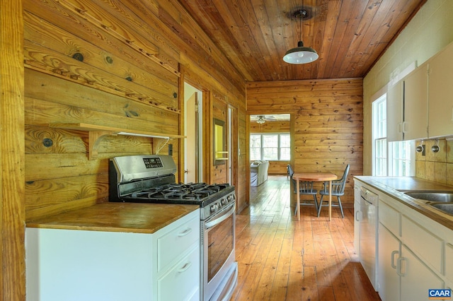 1704 Rugby Cir, Charlottesville, VA 22903 - kitchen with stainless steel gas range oven, white cabinets, light wood finished floors, wood walls, and wooden ceiling