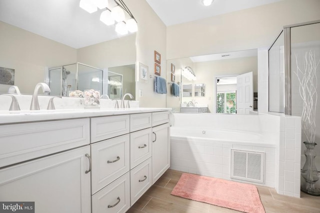 9204 Saint Andrews Ln, Fredericksburg, VA 22408 - bathroom with double vanity, a bath, and a stall shower