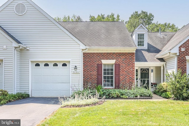 9204 Saint Andrews Ln, Fredericksburg, VA 22408 - view of front of home featuring asphalt driveway, brick siding, a garage, roof with shingles, and a front yard
