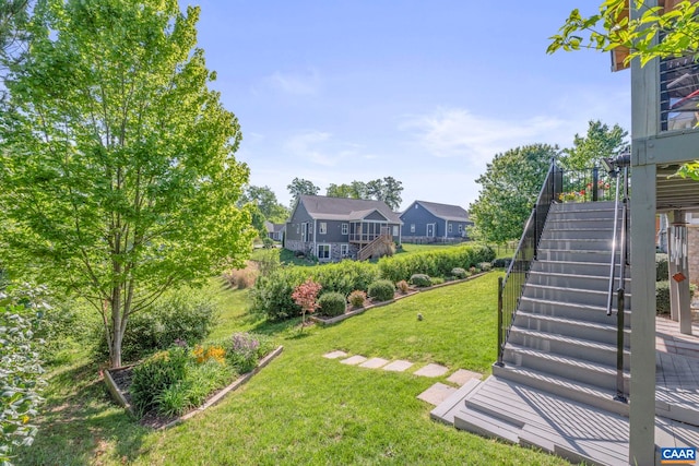 view of grassy yard with stairway