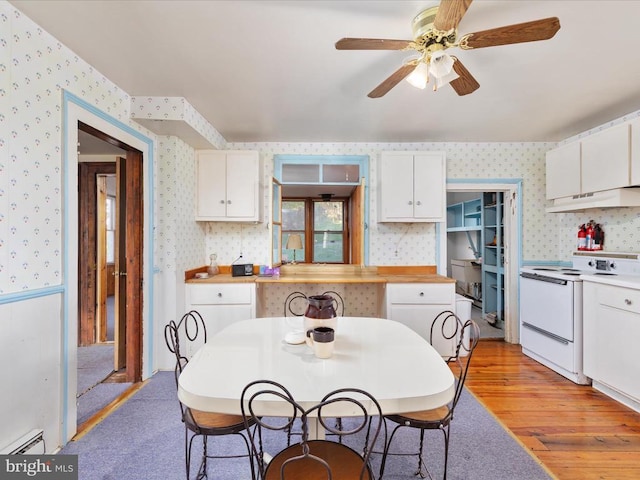 772 Kauffmans Mill Rd, Luray, VA 22835 - kitchen with electric stove, wallpapered walls, under cabinet range hood, white cabinets, and light wood-style flooring