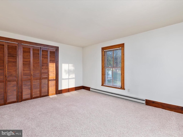 772 Kauffmans Mill Rd, Luray, VA 22835 - unfurnished bedroom featuring a baseboard heating unit, carpet floors, baseboards, and two closets