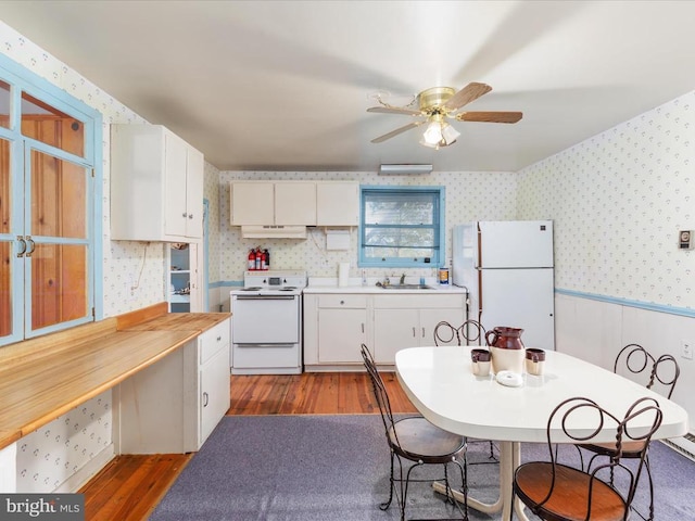 772 Kauffmans Mill Rd, Luray, VA 22835 - kitchen featuring white appliances, wallpapered walls, a sink, wood finished floors, and white cabinetry