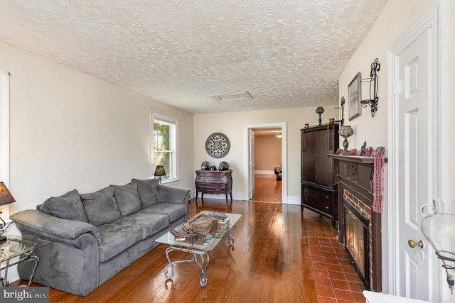 199 Peliso Ave, Orange, VA 22960 - living area featuring dark wood-style flooring, a fireplace, a textured ceiling, and baseboards