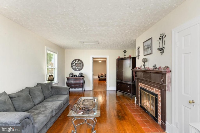 199 Peliso Ave, Orange, VA 22960 - living room featuring wood finished floors, a textured ceiling, a fireplace, and baseboards