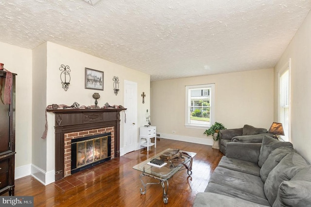 199 Peliso Ave, Orange, VA 22960 - living room with wood finished floors, a brick fireplace, baseboards, and a textured ceiling