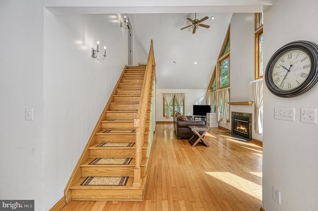 7312 Sugar Hollow Rd, Orange, VA 22960 - stairway featuring high vaulted ceiling, wood-type flooring, a ceiling fan, a high end fireplace, and baseboards
