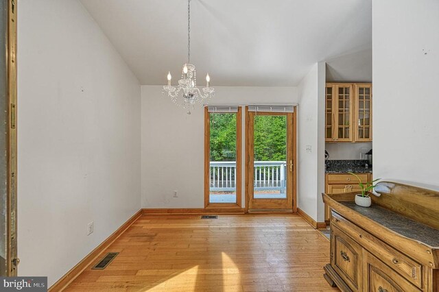 7312 Sugar Hollow Rd, Orange, VA 22960 - unfurnished dining area featuring a chandelier, light wood-style flooring, and baseboards