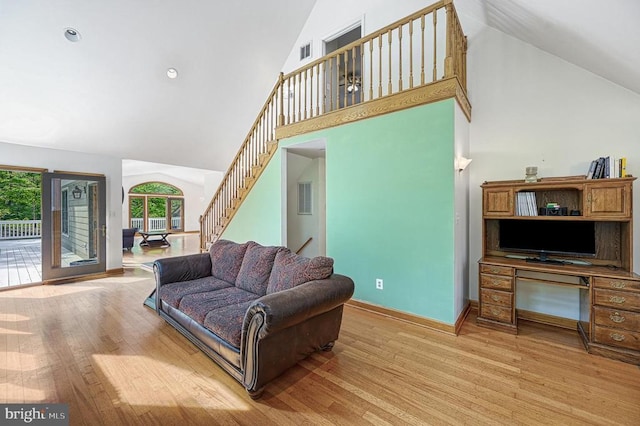 7312 Sugar Hollow Rd, Orange, VA 22960 - living room with high vaulted ceiling, plenty of natural light, light wood finished floors, and stairs
