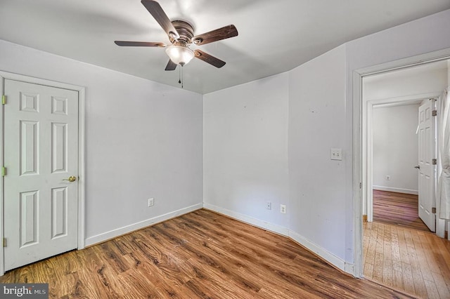 7312 Sugar Hollow Rd, Orange, VA 22960 - unfurnished bedroom with wood finished floors, baseboards, and a ceiling fan