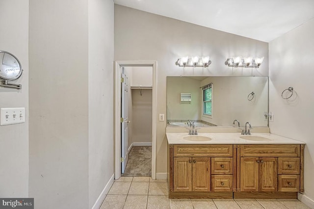 7312 Sugar Hollow Rd, Orange, VA 22960 - full bath featuring vaulted ceiling, tile patterned floors, baseboards, and double vanity