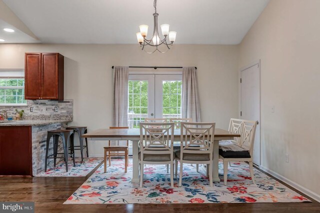  - dining area with healthy amount of natural light, dark wood finished floors, a chandelier, french doors, and recessed lighting