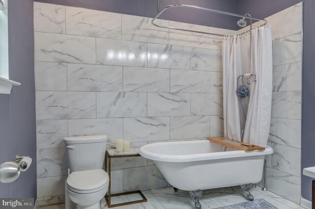  - bathroom with marble finish flooring, a freestanding bath, tile walls, and a shower with curtain