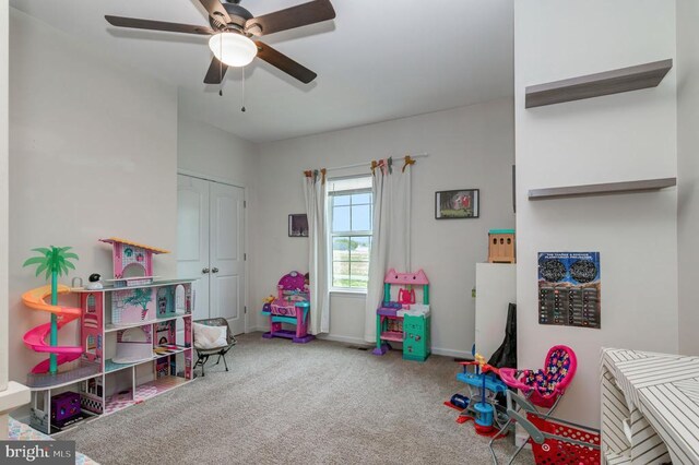  - playroom with a ceiling fan and carpet