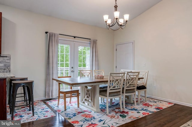  - dining area with wood finished floors, a chandelier, and french doors