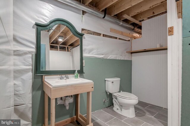  - bathroom featuring toilet and tile patterned flooring