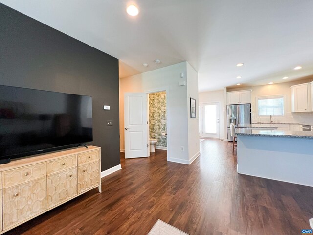 staircase with wood finished floors, ceiling fan, and recessed lighting