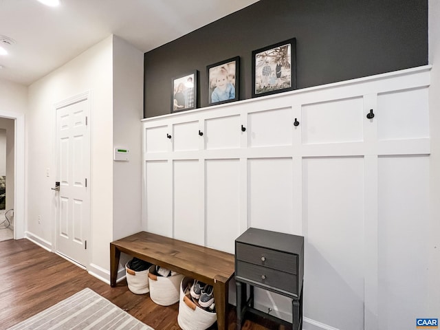 mudroom with dark wood-style flooring and baseboards