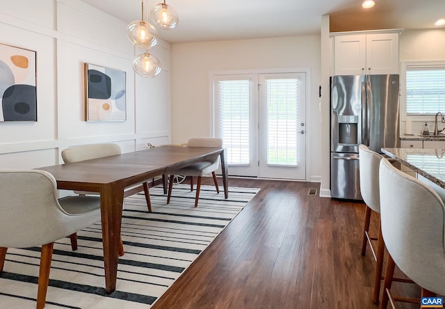 dining space featuring dark wood finished floors and recessed lighting