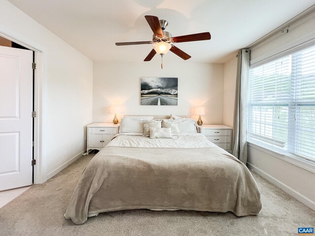 carpeted bedroom featuring multiple windows, a ceiling fan, access to exterior, and baseboards