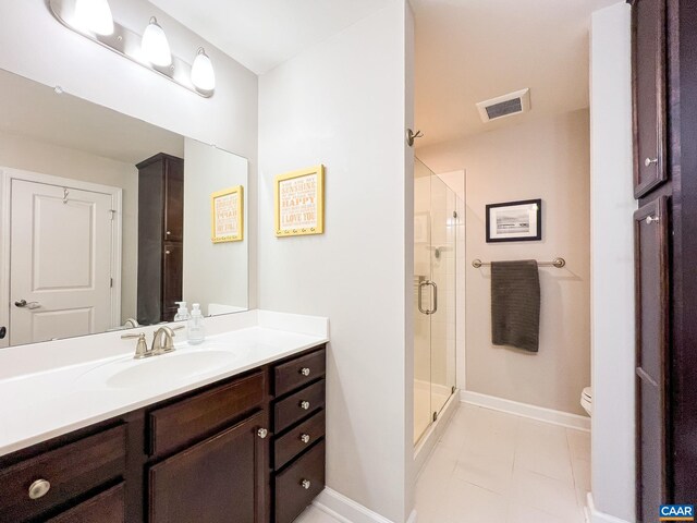 bathroom with tile patterned floors, vanity, baseboards, and toilet