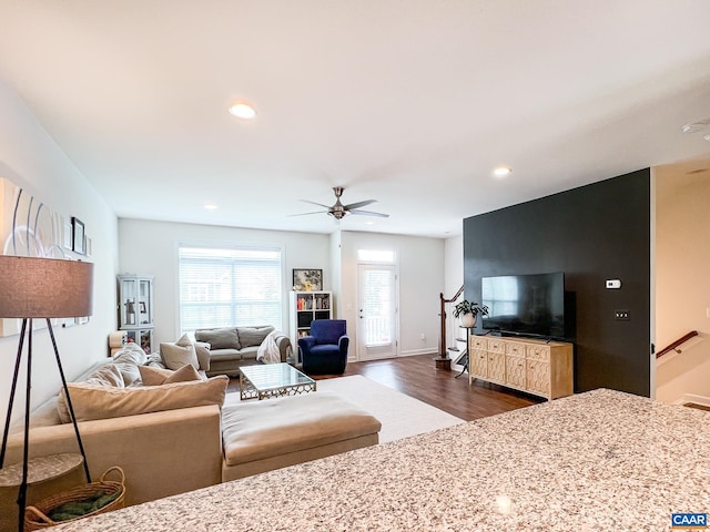 living area with dark wood finished floors, a ceiling fan, recessed lighting, and baseboards