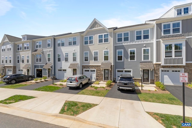 6031 Mccomb St, Crozet, VA 22932 - townhome / multi-family property with driveway, stone siding, a garage, and board and batten siding