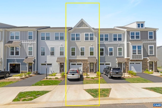 6031 Mccomb St, Crozet, VA 22932 - townhome / multi-family property featuring board and batten siding, driveway, stone siding, and a garage