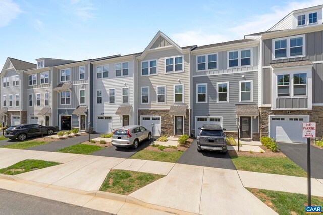 6031 Mccomb St, Crozet, VA 22932 - townhome / multi-family property with driveway, stone siding, a garage, and board and batten siding