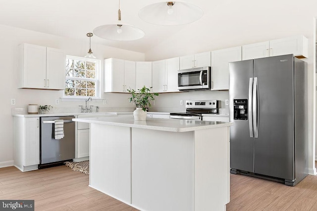 206 Seclusion Shores Dr, Mineral, VA 23117 - kitchen with stainless steel appliances, a sink, light wood finished floors, light countertops, and decorative light fixtures