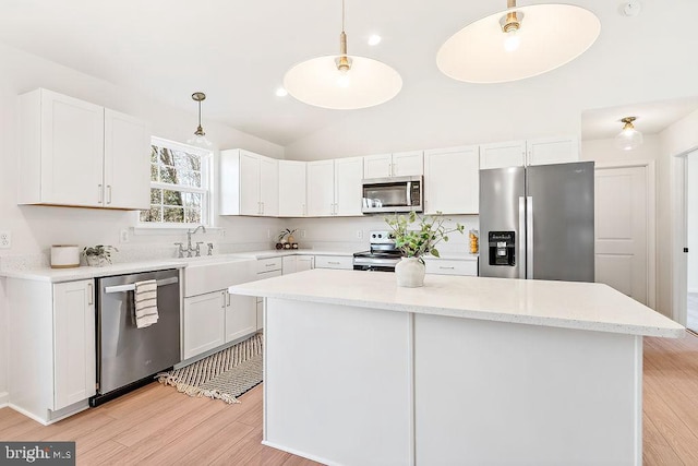 206 Seclusion Shores Dr, Mineral, VA 23117 - kitchen featuring appliances with stainless steel finishes, white cabinets, lofted ceiling, hanging light fixtures, and light wood-style floors