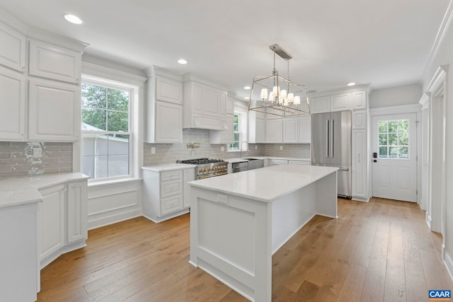 1108 E Jefferson St, Charlottesville, VA 22902 - kitchen with premium appliances, plenty of natural light, a chandelier, white cabinetry, and recessed lighting
