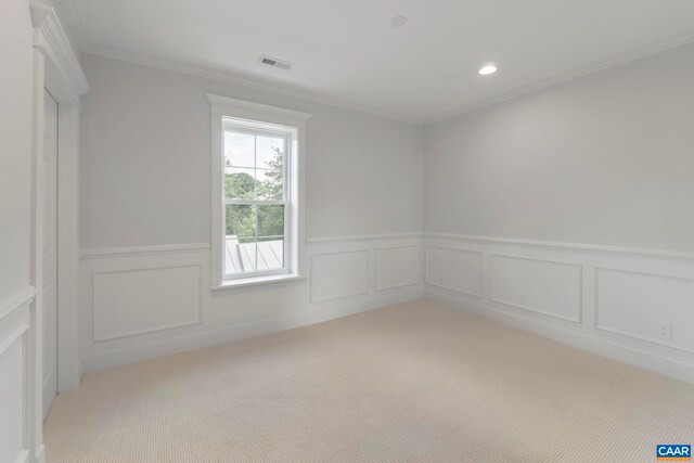 1108 E Jefferson St, Charlottesville, VA 22902 - empty room with light colored carpet, a wainscoted wall, ornamental molding, recessed lighting, and a decorative wall