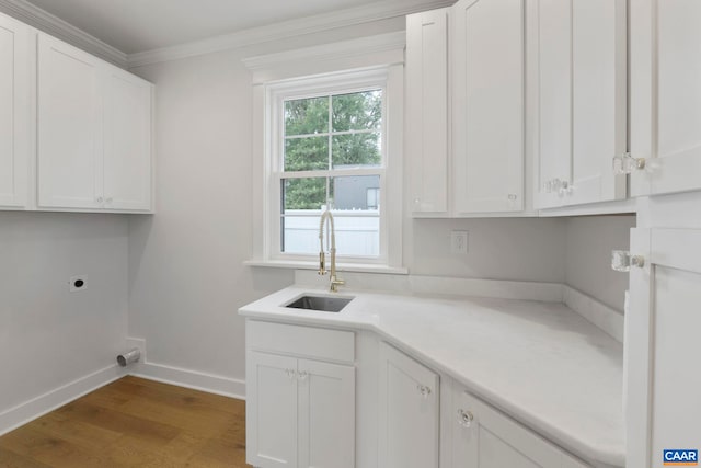 1108 E Jefferson St, Charlottesville, VA 22902 - laundry room with electric dryer hookup, wood finished floors, crown molding, and cabinet space