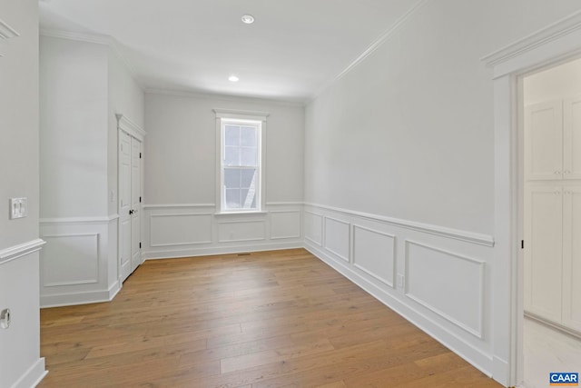 1108 E Jefferson St, Charlottesville, VA 22902 - unfurnished room with crown molding, light wood-style flooring, a wainscoted wall, recessed lighting, and a decorative wall