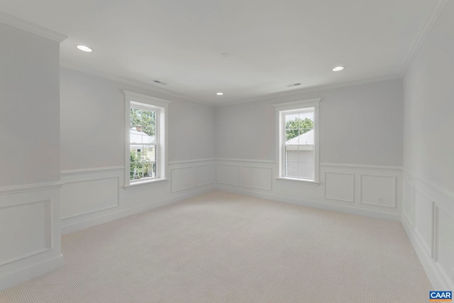 1108 E Jefferson St, Charlottesville, VA 22902 - empty room with light carpet, healthy amount of natural light, ornamental molding, a wainscoted wall, and recessed lighting