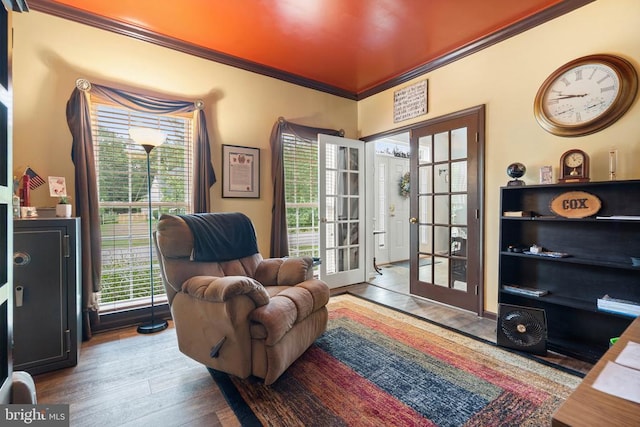  - living area featuring french doors, ornamental molding, and wood finished floors