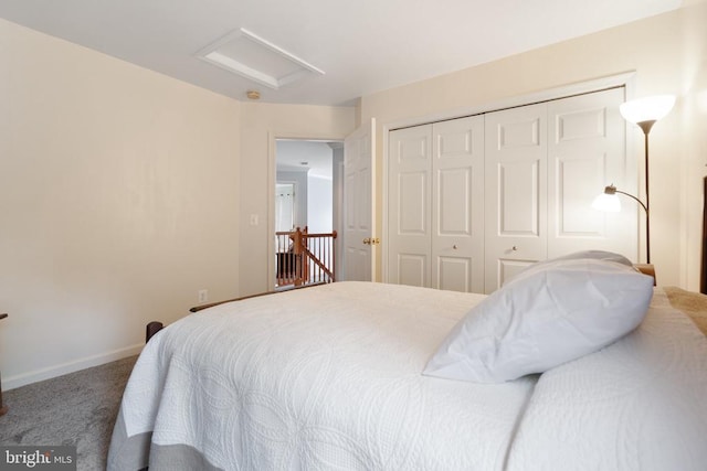  - carpeted bedroom with attic access and a closet