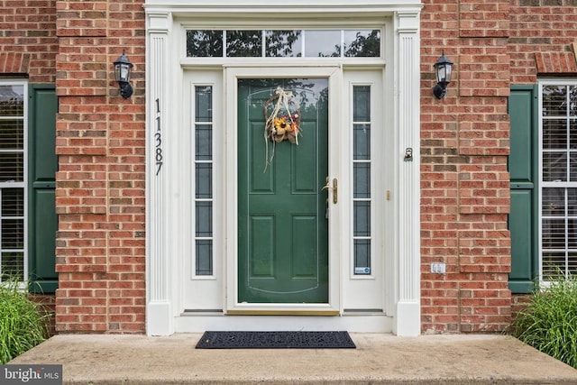  - doorway to property with brick siding