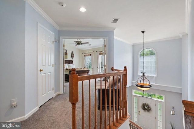  - hallway featuring an upstairs landing, crown molding, and carpet